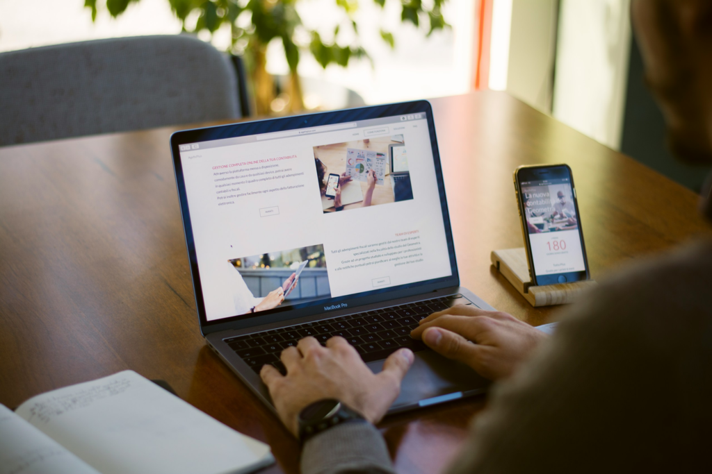 Computer Screen with person sitting at it